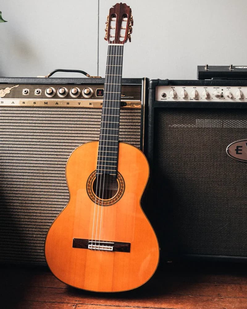 Amalio Burguet 2F guitar leaning on studio amplifiers